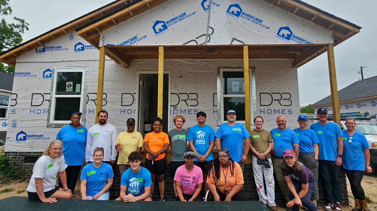 Habitat volunteers working together on a home build site